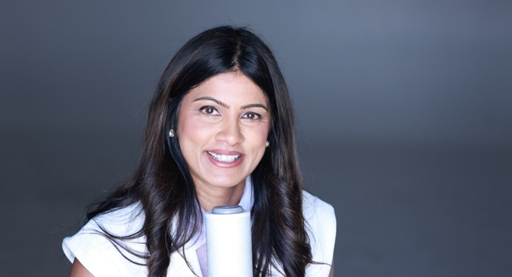 Dr. Sonal Patel laughing, holding a microphone