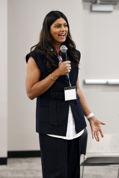 Dr. Sonal Patel speaking into a microphone, mid-conversation with an audience